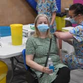 Lisa Szirtes of Sleaford receiving the 1 millionth vaccination in Lincolnshire, at PRSA vaccination centre. The vaccinator is Sam Prichard EMN-210723-142549001