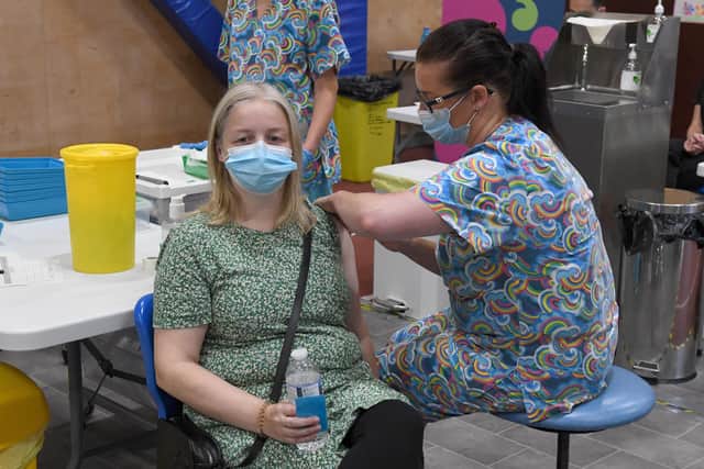 Lisa Szirtes of Sleaford receiving the 1 millionth vaccination in Lincolnshire, at PRSA vaccination centre. The vaccinator is Sam Prichard EMN-210723-142549001