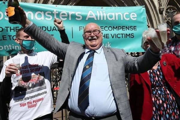Tom Hedges celebrating with a bottle of Prosecco outside the Royal Courts of Justice in London.