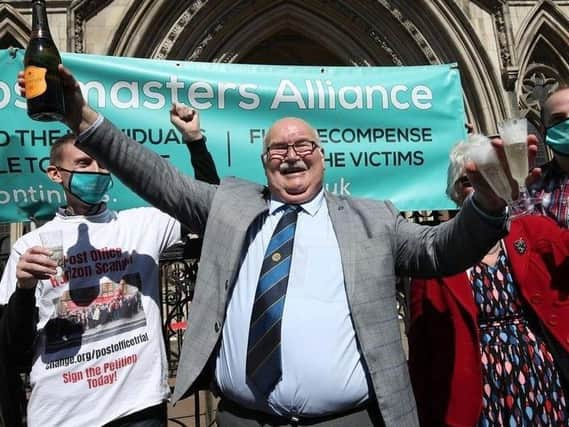 Tom Hedges celebrating with a bottle of Prosecco outside the Royal Courts of Justice in London.