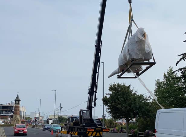 W-raptor - a headless dinosaur in bubble wrap is lifted by crane into a new attraction in Skegness at the former Model Village site.