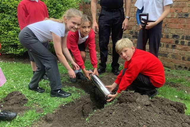 Reburying the time capsules at Ruskington Chestnut Street Academy. EMN-210728-164616001