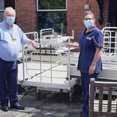 Twenty redundant beds destined for scrap were donated to the Jacob's Well Appeal in Beverley recently. They will use them to furnish a newly-built hospital in Ghana. Pictured is Goole Matron, Kerry Owen, and Grahame Williams, Logistics and Waste Officer, with the beds prior to loading.