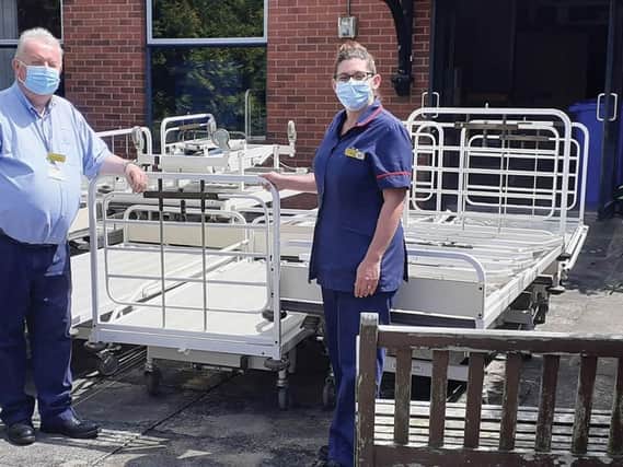 Twenty redundant beds destined for scrap were donated to the Jacob's Well Appeal in Beverley recently. They will use them to furnish a newly-built hospital in Ghana. Pictured is Goole Matron, Kerry Owen, and Grahame Williams, Logistics and Waste Officer, with the beds prior to loading.