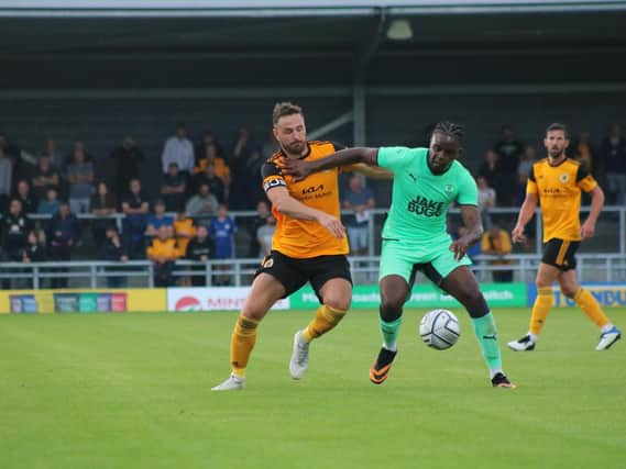 Luke Shiels battles against Notts County. Photo: Oliver Atkin