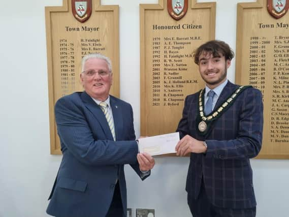 Deputy Mayor Coun Billy Brookes presents a cheque for £450 to Skegness Rotary Club member Coun Tony Tye.