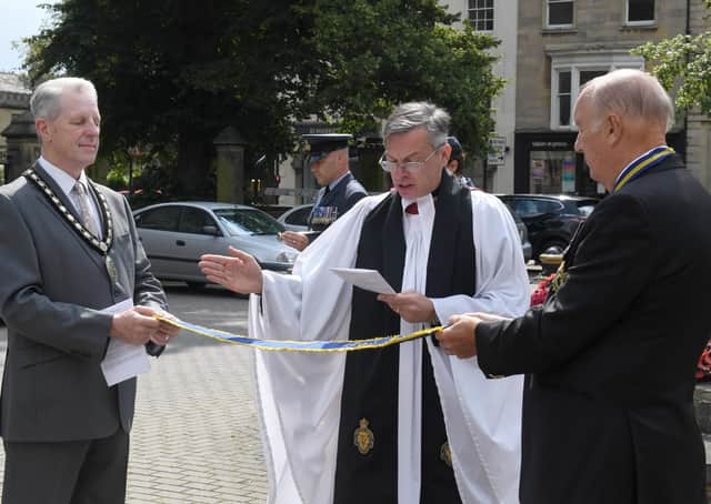 Rev Philip Johnson blessing the pennant that was awarded to the Sleaford and District branch of RBL, marking the 100 year anniversary. EMN-210908-091717001