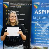 Asher Williams of Caythorpe getting her A-level results at Sir William Robertson Academy. EMN-211008-122654001