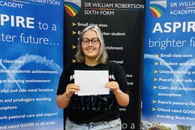 Asher Williams of Caythorpe getting her A-level results at Sir William Robertson Academy. EMN-211008-122654001