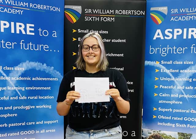 Asher Williams of Caythorpe getting her A-level results at Sir William Robertson Academy. EMN-211008-122654001