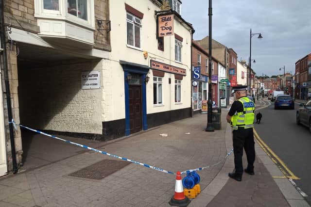 A police officer guards the scene of a serious assault which took place outside the Bull and Dog pub in Sleaford on Saturday morning. EMN-210814-133135001