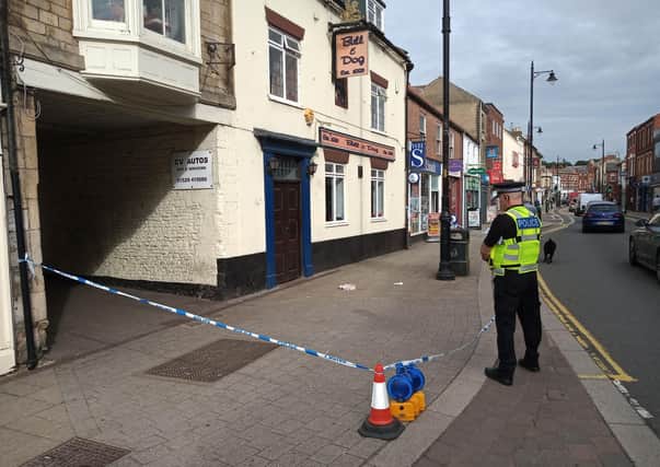 A police officer guards the scene of a serious assault which took place outside the Bull and Dog pub in Sleaford on Saturday morning. EMN-210814-133135001