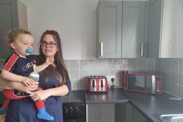 Hollie with Regan-James, 18 months, in their new kitchen.