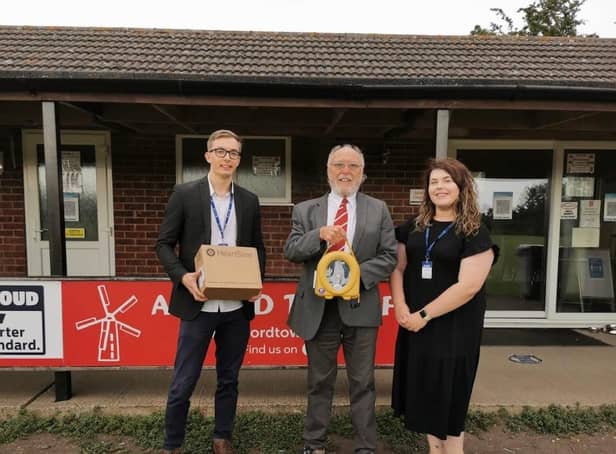 Connor Storr and Teri Beardsley of Safelincs are pictured with Alford Town secretary Rob Wilson.