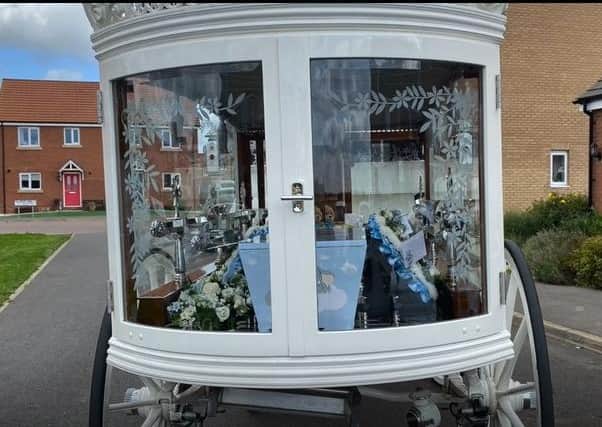 Baby Archie's tiny coffin in the white carriage outside the home of his family in Skegness.