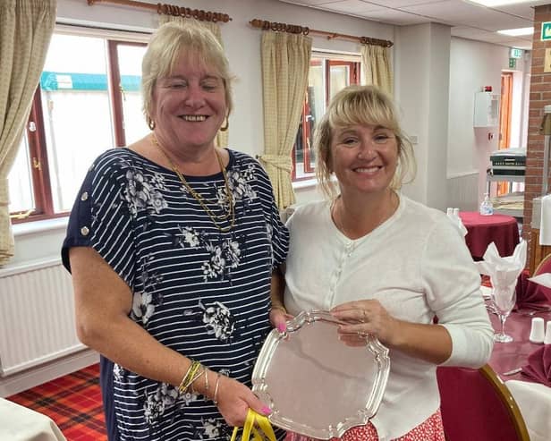 Rachel Jones is seen receiving her trophy from Karen Rawson.