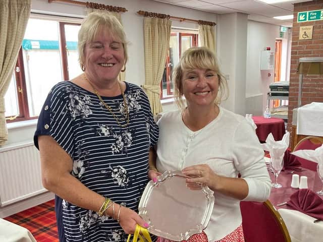 Rachel Jones is seen receiving her trophy from Karen Rawson.