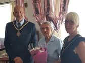 Mary Clay (centre) had a surprise visit from Mayor of Skegness Coun Trevor Burnham for her 100th birthday.