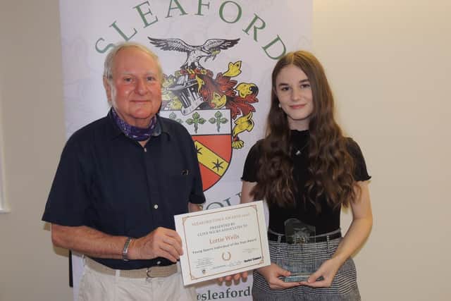 Footballer Lottie Wells receives the Young Sports Individual Award 2020 from past Mayor of Sleaford, Coun Anthony Brand. EMN-210727-172705001