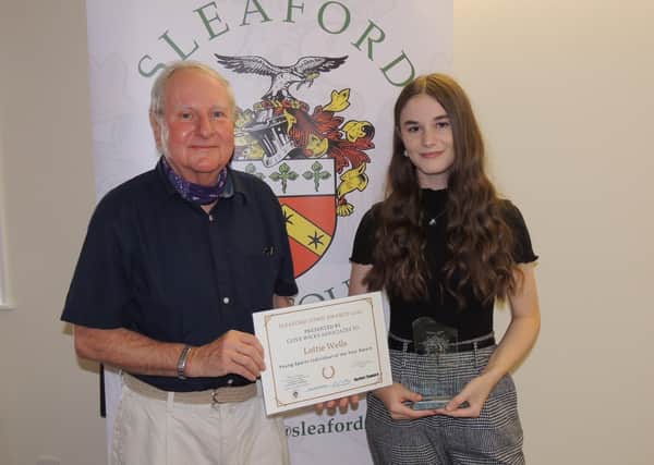 Footballer Lottie Wells receives the Young Sports Individual Award 2020 from past Mayor of Sleaford, Coun Anthony Brand. EMN-210727-172705001