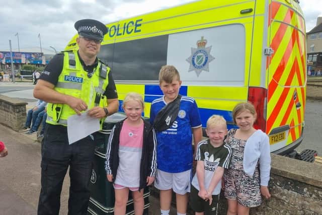 Insp Colin Haigh handing out Lincolnshire Police stickers to children while on patrol in Skegness.
