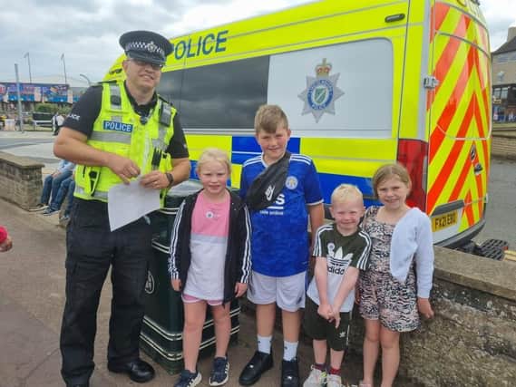 Insp Colin Haigh handing out Lincolnshire Police stickers to children while on patrol in Skegness.