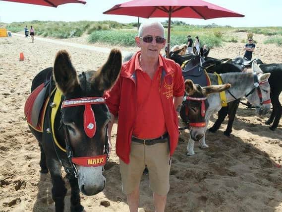 John Nuttall is the third generation of a family giving donkey rides to children on Skegness beach.