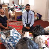 Local generosity. From left - Nadim Aziz and son Safayth Hussain with the piles of donations for Afghan refugees they received within hours of putting out an appeal. EMN-210825-171911001