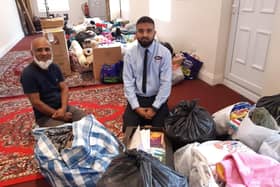 Local generosity. From left - Nadim Aziz and son Safayth Hussain with the piles of donations for Afghan refugees they received within hours of putting out an appeal. EMN-210825-171911001