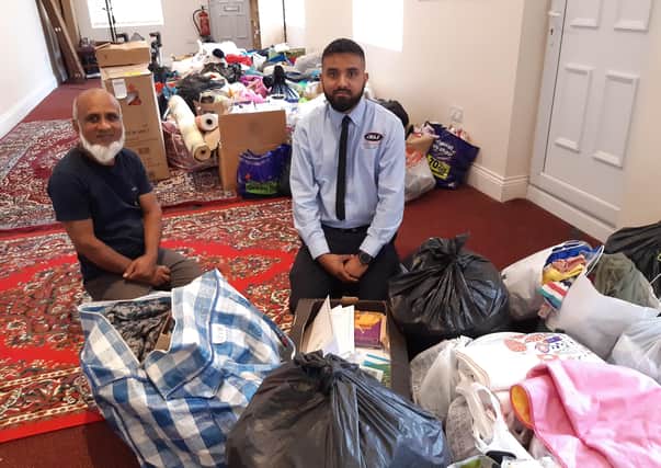 Local generosity. From left - Nadim Aziz and son Safayth Hussain with the piles of donations for Afghan refugees they received within hours of putting out an appeal. EMN-210825-171911001