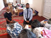 Local generosity. From left - Nadim Aziz and son Safayth Hussain with the piles of donations for Afghan refugees they received within hours of putting out an appeal. EMN-210825-171911001
