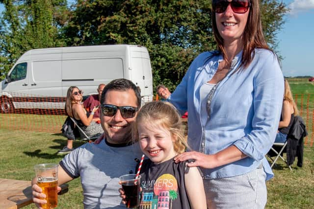 Antony Hampson, Teana Hampson and Harriet Hampson age 6 at the Coach and Horses beer fest. EMN-210830-114238001