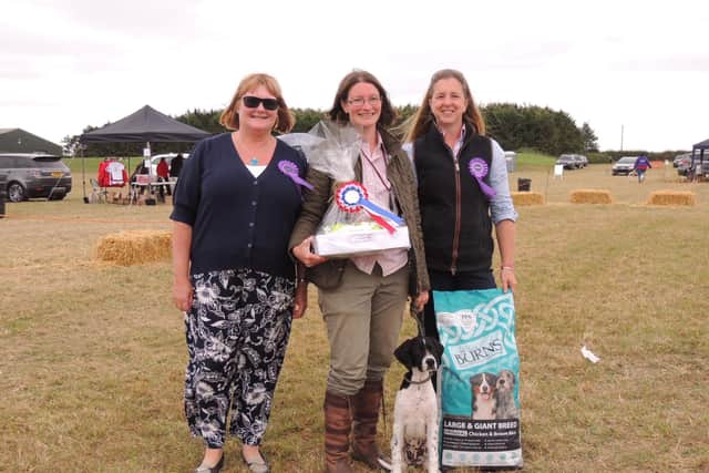 Overall champion at the Cranwell Bloodhounds dog show, Hannah Welch of Bucknall and three-and-a-half month old English Pointer, Shifty, with judges Jo Leach and Leigh Robson. EMN-210830-130011001