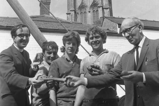 Pictured examining the bones are (from left) Mr Duce, site workmen Terry Kirk, Alan MacIntyre and Sebastian Dangerfield, and Mr R. Baker, the parish church verger.