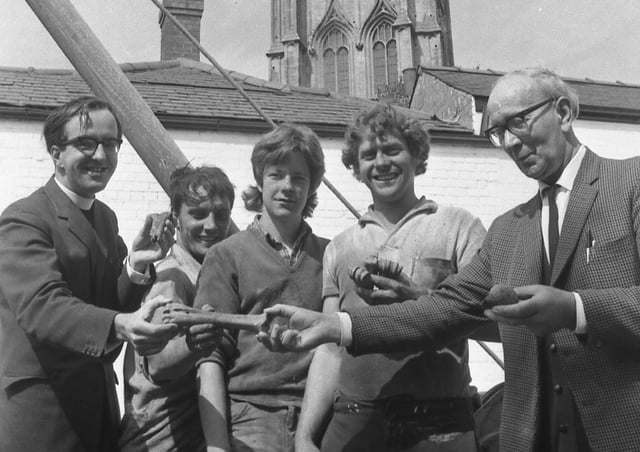 Pictured examining the bones are (from left) Mr Duce, site workmen Terry Kirk, Alan MacIntyre and Sebastian Dangerfield, and Mr R. Baker, the parish church verger.
