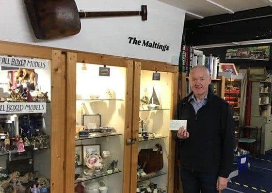 Andrew Leonard with the cheque at the Old Maltings Antiques Centre.