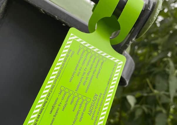 Bin crews will add advisory tags to wheelie bins containing the wrong recyclable waste. EMN-210913-164247001