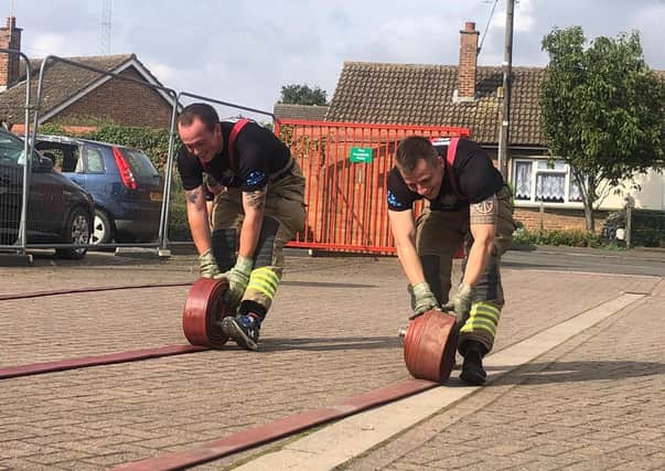 Back-aching work for Billingborough firefighters in their hose challenge. EMN-210913-125916001