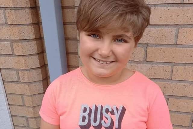 Cat loving nine-year-old Amelia after her hair chop for charity. EMN-211009-165515001