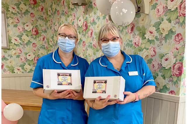 Donna Osborn and Julie Bee, of Avocet House Care Home, with movie night-in bundles.