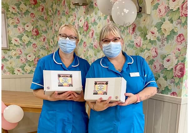 Donna Osborn and Julie Bee, of Avocet House Care Home, with movie night-in bundles.