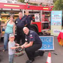 The fire and ambulance station open day was a family affair. From left - Andrew and Alex Failes of Ancaster with son Rowan, 3, meet the Lincolnshire Fire and Resxcue Volunteer Support Service who attend charity events and open days to relieve the front line fire crews as well as helping with tactical and operational training - Mark Smith, Adrian Gledhill and Benjamin Smith. (Also Tom Kirby not pictured). EMN-210920-132535001