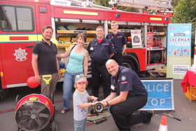 The fire and ambulance station open day was a family affair. From left - Andrew and Alex Failes of Ancaster with son Rowan, 3, meet the Lincolnshire Fire and Resxcue Volunteer Support Service who attend charity events and open days to relieve the front line fire crews as well as helping with tactical and operational training - Mark Smith, Adrian Gledhill and Benjamin Smith. (Also Tom Kirby not pictured). EMN-210920-132535001