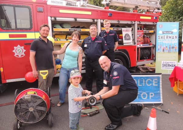 The fire and ambulance station open day was a family affair. From left - Andrew and Alex Failes of Ancaster with son Rowan, 3, meet the Lincolnshire Fire and Resxcue Volunteer Support Service who attend charity events and open days to relieve the front line fire crews as well as helping with tactical and operational training - Mark Smith, Adrian Gledhill and Benjamin Smith. (Also Tom Kirby not pictured). EMN-210920-132535001