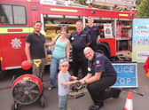 The fire and ambulance station open day was a family affair. From left - Andrew and Alex Failes of Ancaster with son Rowan, 3, meet the Lincolnshire Fire and Resxcue Volunteer Support Service who attend charity events and open days to relieve the front line fire crews as well as helping with tactical and operational training - Mark Smith, Adrian Gledhill and Benjamin Smith. (Also Tom Kirby not pictured). EMN-210920-132535001