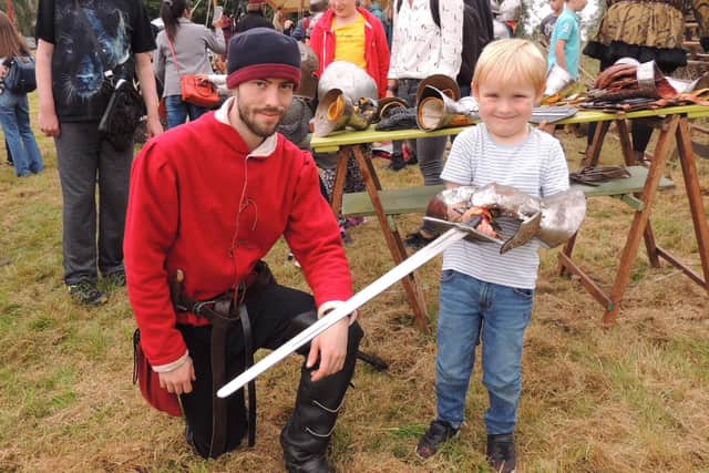 Oliver Bellamy from the Knights of Skirbeck lets Oliver Beattie, 5, of Rippingale, try out his sword. EMN-210920-133252001
