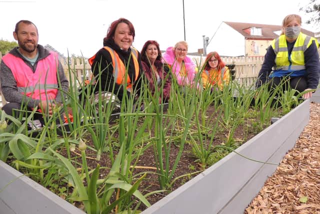 Poacher Line volunteers and members of Rainbow Stars at the new allotment on Sleaford station. EMN-210920-173912001
