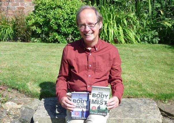 Nick Louth with two of his previous books in the DCI Gillard crime thriller series.
