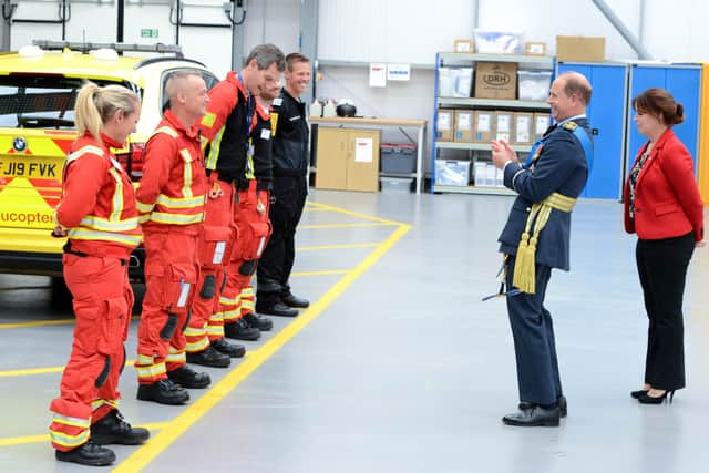 The Earl of Wessex shares a joke with the air ambulance crew. EMN-210930-093033001