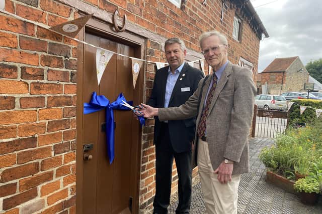 Coun Richard Wright and Malcolm Smith cutting the ribbon to Mrs Smith’s Cottage. EMN-210210-141045001